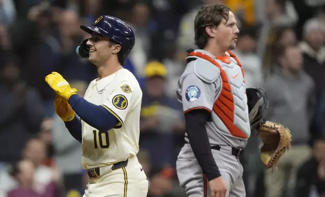 Milwaukee Brewers' Sal Frelick (10) celebrates in front of Baltimore Orioles' Adley Rutschman after hitting a two-run home run during the fourth inning of a baseball game, Tuesday, May 20, 2025, in Milwaukee. (AP Photo/Aaron Gash)