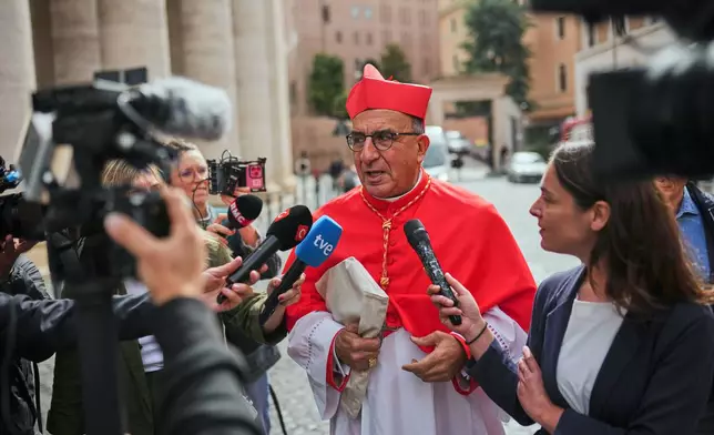 Cardinal Fernando Natalio Chomali Garib talks to journalists as he arrives at the Vatican, Friday, May 9, 2025, a day after Pope Leo XIV was elected as the first North American pope. (AP Photo/Francisco Seco)