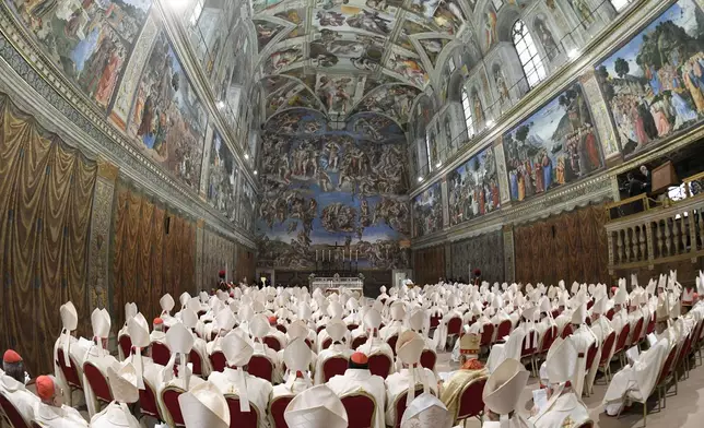 Newly elected Pope Leo XIV, seated at the back left, concelebrates Mass with the College of Cardinals inside the Sistine Chapel at the Vatican the day after his election as 267th pontiff of the Roman Catholic Church, Friday, May 9, 2025. (Vatican Media via AP)