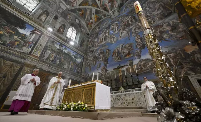 Newly elected Pope Leo XIV, second from left, concelebrates Mass with the College of Cardinals inside the Sistine Chapel at the Vatican the day after his election as 267th pontiff of the Roman Catholic Church, Friday, May 9, 2025. (Vatican Media via AP)