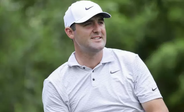 Scottie Scheffler watches his drive on the sixth tee during the first round of the CJ Cup Byron Nelson golf tournament, Thursday, May 1, 2025, in McKinney, Texas. (AP Photo/Gareth Patterson)