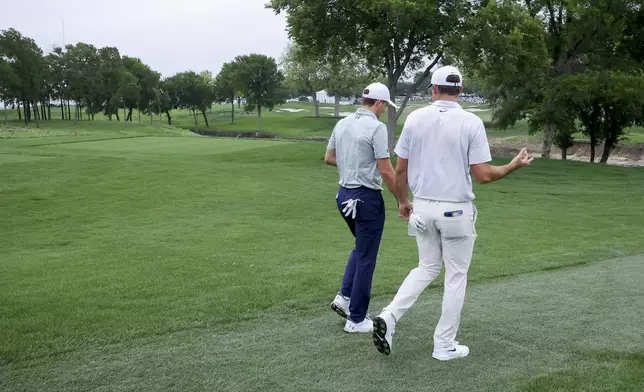 Jordan Spieth, left, and Scottie Scheffler, right, walk the sixth fairway together during the first round of the CJ Cup Byron Nelson golf tournament in McKinney, Texas, Thursday, May 1, 2025. (AP Photo/Gareth Patterson)
