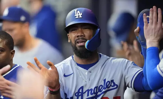 Los Angeles Dodgers' Teoscar Hernández (37) celebrates a run off the batt of Los Angeles Dodgers third baseman Max Muncy (13) in the fourth inning of a baseball game against the Atlanta Braves, Sunday, May 4, 2025, in Atlanta. (AP Photo/Mike Stewart)