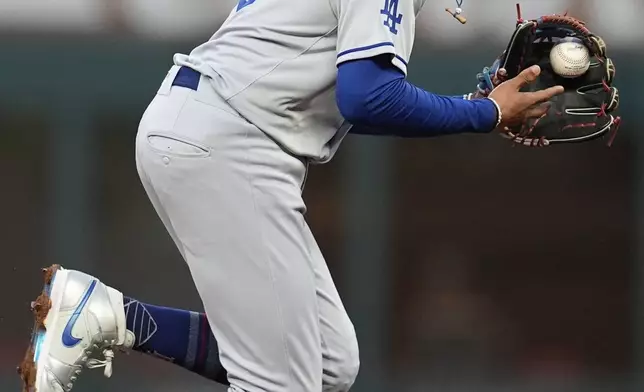 Los Angeles Dodgers shortstop Mookie Betts (50) fields a ball hit by Atlanta Braves' Nick Allen in the fourth inning of a baseball game, Sunday, May 4, 2025, in Atlanta. (AP Photo/Mike Stewart)