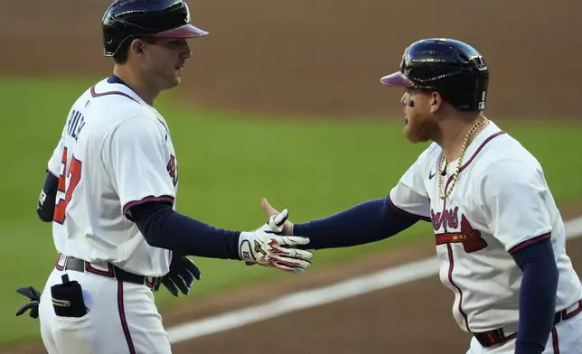 Atlanta Braves third baseman Austin Riley (27) celebrates after hitting a two-run homer against the Los Angeles Dodgers in the first inning of a baseball game, Sunday, May 4, 2025, in Atlanta. (AP Photo/Mike Stewart)