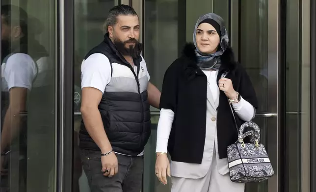 Odai Al Fayoumi, left, father of Wadee Al Fayoumi, who was murdered by Joseph Czuba in 2023, walks out of the Will County Courthouse after the sentencing of Czuba in Joliet, Ill., Friday, May 2, 2025. (Pat Nabong /Chicago Sun-Times via AP)