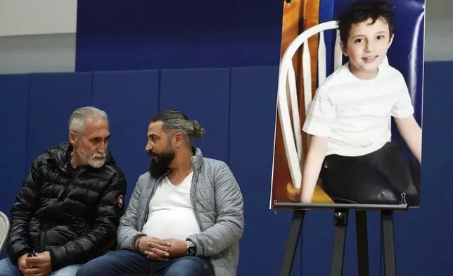 FILE - Wadee Alfayoumi's father, Oday Al Fayoume, seated right, and his uncle Mahmoud Yousef attend a vigil for Wadee at Prairie Activity and Recreation center in Plainfield, Ill., Oct. 17, 2023. (AP Photo/Nam Y. Huh, File)