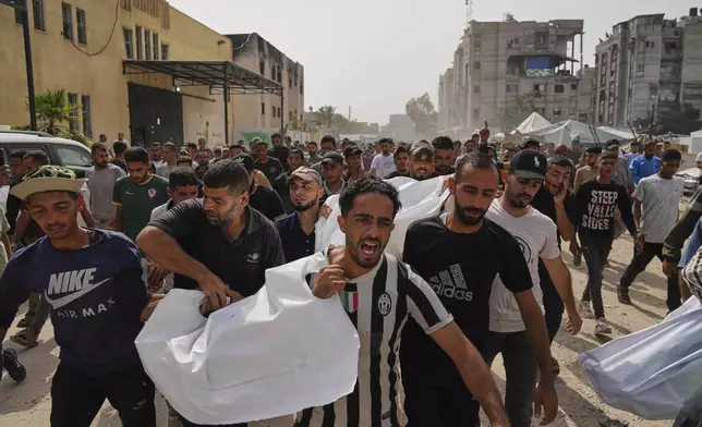 Palestinians carry the bodies of their relatives killed in an Israeli army airstrike, during their funeral in Khan Younis, Gaza Strip, Sunday, May 18, 2025. (AP Photo/Abdel Kareem Hana)