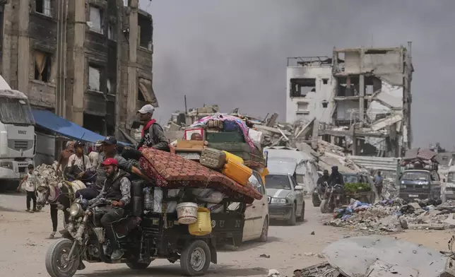 Displaced Palestinians fleeing Beit Lahia amid ongoing Israeli military operations in the Gaza Strip arrive in Jabalia, northern Gaza, on Sunday, May 18, 2025. (AP Photo/Jehad Alshrafi)
