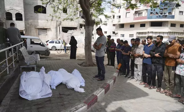 Palestinians pray over the bodies of victims of an Israeli army strike on a house belonging to the Jabr family during their funeral outside the al-Shifa hospital in Gaza City, Sunday, May 18, 2025. (AP Photo/Jehad Alshrafi)