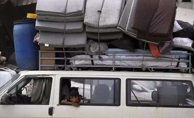 Displaced Palestinians fleeing Beit Lahia amid ongoing Israeli military operations in the Gaza Strip arrive in Jabalia, northern Gaza, on Sunday, May 18, 2025. (AP Photo/Jehad Alshrafi)