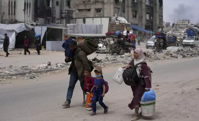 Displaced Palestinians fleeing Beit Lahia amid ongoing Israeli military operations in the Gaza Strip arrive in Jabalia, northern Gaza, on Sunday, May 18, 2025. (AP Photo/Jehad Alshrafi)