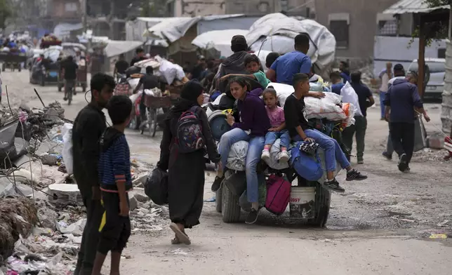 Displaced Palestinians fleeing Beit Lahia amid ongoing Israeli military operations in the Gaza Strip arrive in Jabalia, northern Gaza, on Sunday, May 18, 2025. (AP Photo/Jehad Alshrafi)