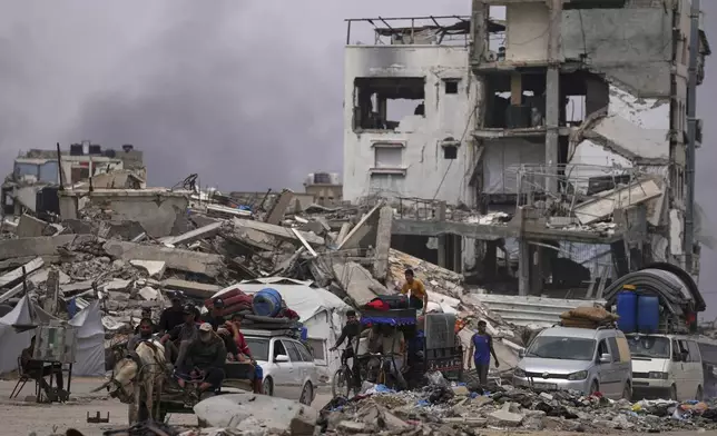 Displaced Palestinians fleeing Beit Lahia amid ongoing Israeli military operations in the Gaza Strip arrive in Jabalia, northern Gaza, on Sunday, May 18, 2025. (AP Photo/Jehad Alshrafi)