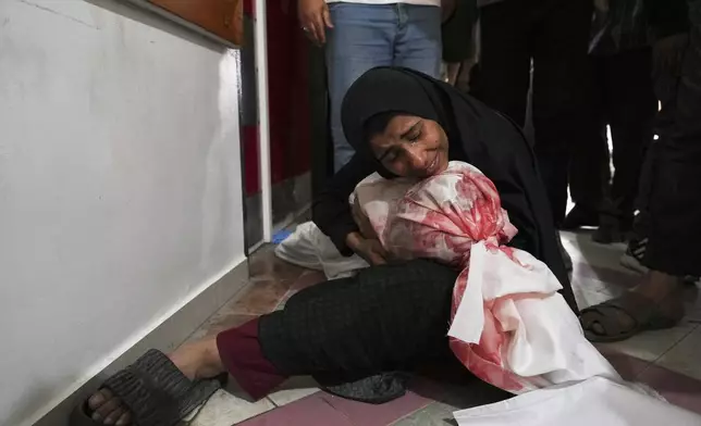A Palestinian woman mourns her son, killed in an Israeli airstrikes in Jabalia, northern Gaza Strip, on Wednesday, May 14, 2025. According to local hospitals, 48 people were killed in the strikes, including 22 children. (AP Photo/Jehad Alshrafi)