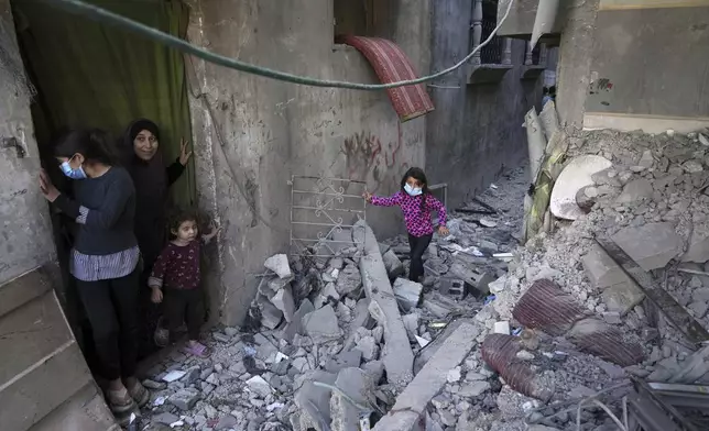 Palestinians inspect the rubble of homes destroyed by Israeli airstrikes in Jabalia, northern Gaza Strip, on Wednesday, May 14, 2025. According to local hospitals, 48 people were killed in the strikes, including 22 children. (AP Photo/Jehad Alshrafi)
