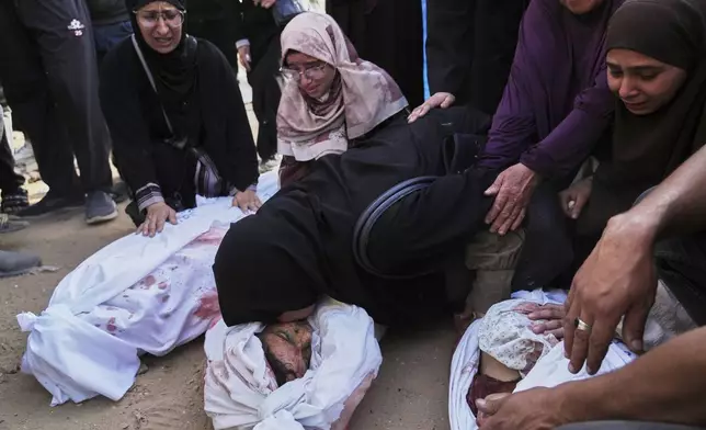 Palestinians mourn children from their families who were killed in Israeli airstrikes in Jabalia, in the northern Gaza Strip, on Wednesday, May 14, 2025. According to local hospitals, the strikes killed 48 people, including 22 children. (AP Photo/Jehad Alshrafi)