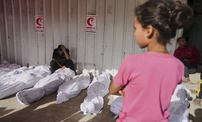 Palestinians mourn their relatives killed in an Israeli airstrikes in Jabalia, northern Gaza Strip, on Wednesday, May 14, 2025. According to local hospitals, 48 people were killed in the strikes, including 22 children. (AP Photo/Jehad Alshrafi)