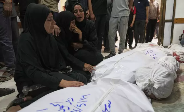Palestinians mourn their relatives killed in an Israeli airstrikes in Jabalia, northern Gaza Strip, on Wednesday, May 14, 2025. According to local hospitals, 48 people were killed in the strikes, including 22 children. (AP Photo/Jehad Alshrafi)