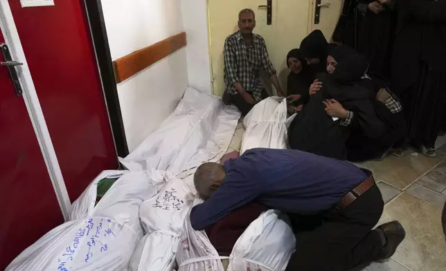 Palestinians mourn their relatives killed in an Israeli airstrikes in Jabalia, northern Gaza Strip, on Wednesday, May 14, 2025. According to local hospitals, 48 people were killed in the strikes, including 22 children. (AP Photo/Jehad Alshrafi)