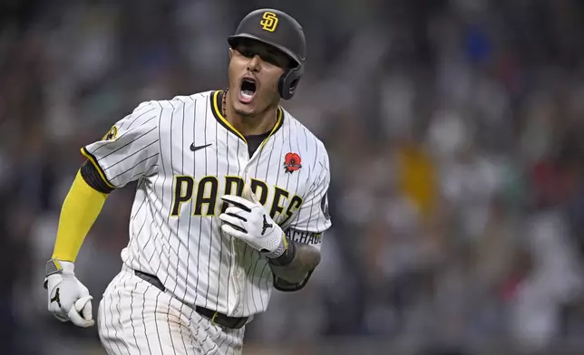 San Diego Padres' Manny Machado celebrates after hitting a home run during the eighth inning of a baseball game against the Miami Marlins, Monday, May 26, 2025, in San Diego. (AP Photo/Orlando Ramirez)