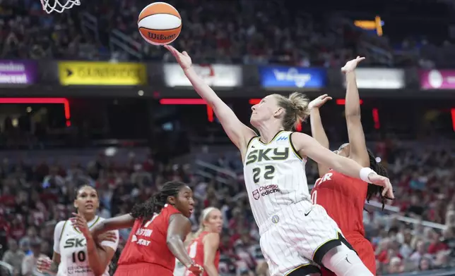 Chicago Sky guard Courtney Vandersloot (22) shoots in front pf Indiana Fever guard Kelsey Mitchell (0) during the first half of a WNBA basketball game in Indianapolis, Saturday, May 17, 2025. (AP Photo/AJ Mast)