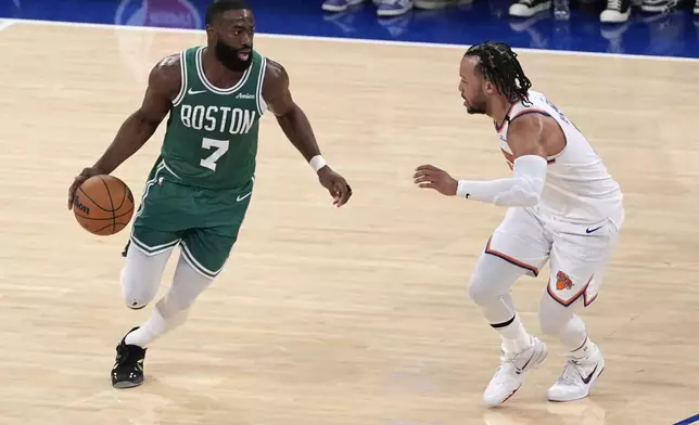 Boston Celtics' Jaylen Brown, left, dribbles the ball against New York Knicks' Jalen Brunson, right, during the second half of Game 3 of an NBA basketball second-round playoff series, Saturday, May 10, 2025, in New York. (AP Photo/Pamela Smith)
