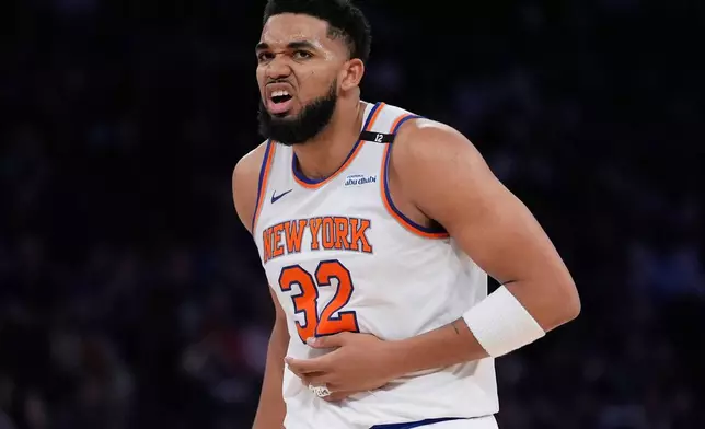 New York Knicks' Karl-Anthony Towns reacts after an injury during the first half against the Boston Celtics in Game 3 of an NBA basketball second-round playoff series, Saturday, May 10, 2025, in New York. (AP Photo/Pamela Smith)