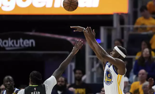 Golden State Warriors forward Jimmy Butler III (10) shoots a 3-point basket over Minnesota Timberwolves center Naz Reid during the second half of Game 3 of an NBA basketball second-round playoff series Saturday, May 10, 2025, in San Francisco. (AP Photo/Godofredo A. Vásquez)