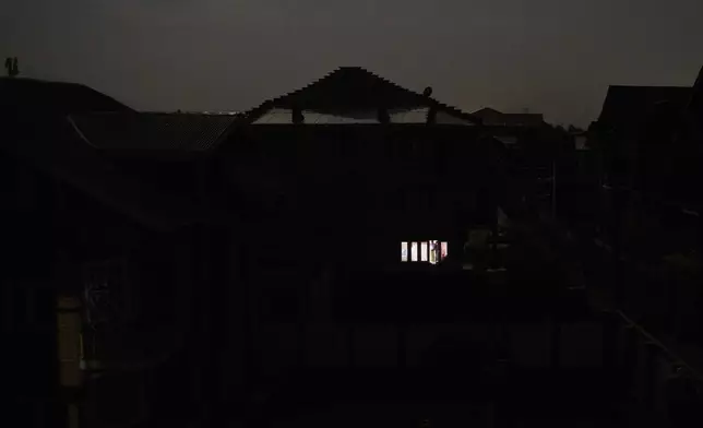A Kashmiri man looks out from the window of his house during blackout after the residents of the Srinagar reported hearing explosions in Srinagar, Indian controlled Kashmir, Saturday, May 10, 2025.(AP Photo/Dar Yasin)