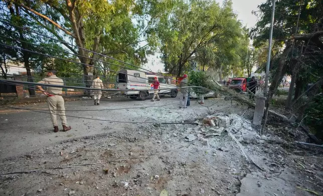 Security personnel secure the area after a Pakistan's drone attack on a residential building in Jammu, India, Saturday, May 10, 2025. (AP Photo/Channi Anand)