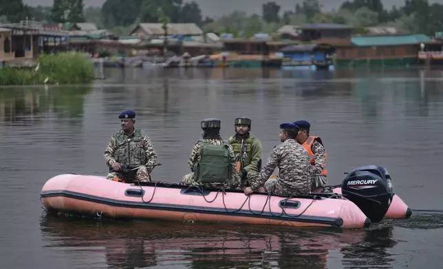 Paramilitary soldiers patrol on an inflatable boat on Dal Lake after loud explosions were heard in Srinagar, Indian controlled Kashmir, Saturday, May 10, 2025.(AP Photo/Mukhtar Khan)