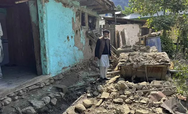 A Kashmiri villager examines damages to his house caused by overnight Indian shelling, in Shah Kot, in Neelum Vallery, a district of Pakistan's administered Kashmir, Saturday, May 10, 2025. (AP Photo/M.D. Mughal)