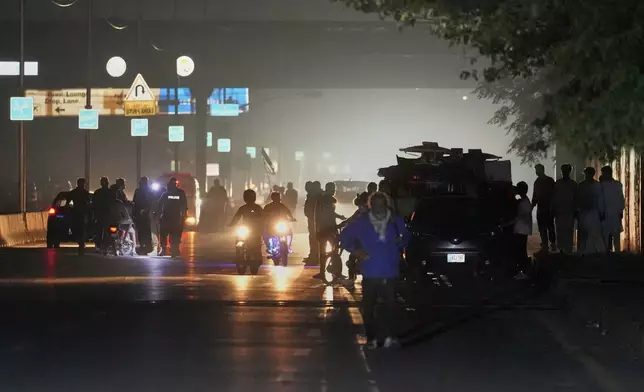 Pakistani police officers remove vehicles and people from the main entry of Nur Khan airbase following an Indian missile strike in Rawalpindi, Pakistan, Saturday, May 10, 2025. (AP Photo/Anjum Naveed)