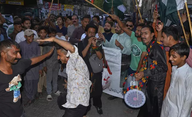 People dance on traditional drum beat as they celebrate following India and Pakistan reaching a ceasefire deal, during a demonstration, in Hyderabad, Pakistan, Saturday, May 10, 2025. (AP Photo/Pervez Masih)