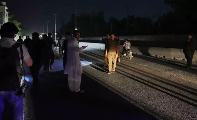 Police officers remove vehicles and people from the main entry of Nur Khan airbase following Indian missile strike on airbase, in Rawalpindi, Pakistan, Saturday, May 10, 2025. (AP Photo/Anjum Naveed)