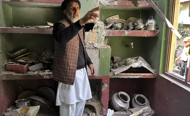 A Kashmiri villager examines damages to his house caused by overnight Indian shelling, in Shah Kot, in Neelum Vallery, a district of Pakistan's administered Kashmir, Saturday, May 10, 2025. (AP Photo/M.D. Mughal)