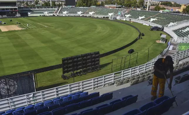 A worker cleans an enclosure of the Rawalpindi Cricket Stadium following the Pakistan Super League resumption, in Rawalpindi, Pakistan, Thursday, May 15, 2025. (AP Photo/W.K. Yousufzai)