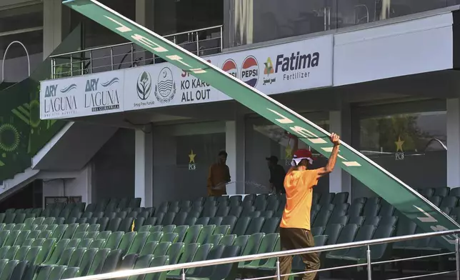 Workers prepare an enclosure of the Rawalpindi Cricket Stadium following the Pakistan Super League resumption, in Rawalpindi, Pakistan, Thursday, May 15, 2025. (AP Photo/W.K. Yousufzai)
