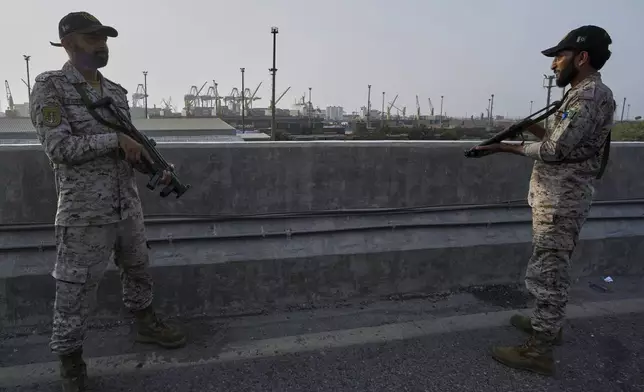 A paramilitary soldier stand alert on a road near Karachi port following raising military tension between Pakistan and India, in Karachi, Pakistan, Friday, May 9, 2025. (AP Photo/Fareed Khan)