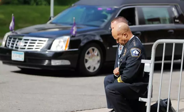 FILE - Police officers, including Minneapolis Police Chief Medaria Arradondo, foreground, take a knee as the body of George Floyd arrives before his memorial services in Minneapolis on June 4, 2020. (AP Photo/Julio Cortez, File)