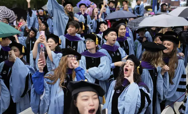 Graduates cheer during the Columbia University commencement ceremony on Columbia's main campus, in Manhattan, on Wednesday, May 21, 2025 in New York. (AP Photo/Seth Wenig, Pool)
