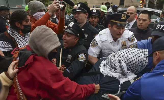 Police and protesters clash across the street from the main gates of Columbia University, Wednesday, May 21, 2025, in New York. (AP Photo/Heather Khalifa)