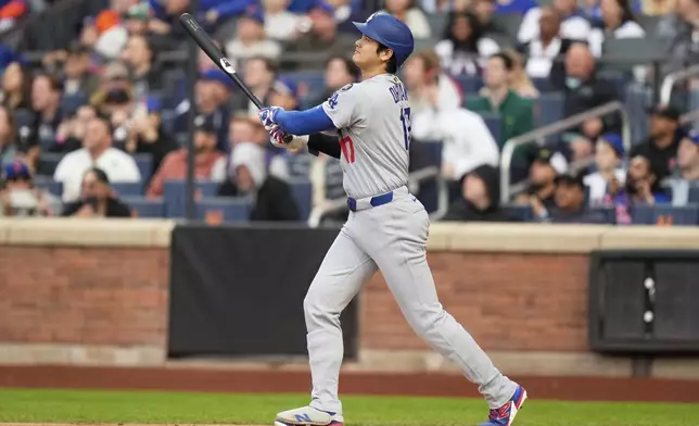 Los Angeles Dodgers' Shohei Ohtani watches his solo home run during the first inning of a baseball game against the New York Mets, Sunday, May 25, 2025, in New York. (AP Photo/Seth Wenig)