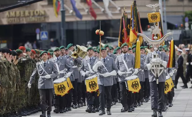 German soldiers march at the formal inauguration of a German brigade for NATO's eastern flank in the center of Vilnius, Lithuania, Thursday, May 22, 2025. (AP Photo/Mindaugas Kulbis)