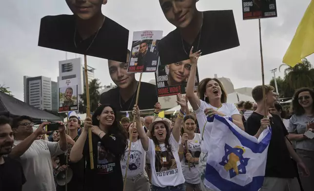 People watch a live broadcast of Israeli-American soldier Edan Alexander as he is released from Hamas captivity in Gaza, at a plaza known as the hostages square in Tel Aviv, Monday, May 12, 2025. Alexander was abducted during the Hamas-led attack on his base on October 7, 2023. (AP Photo/Oded Balilty)