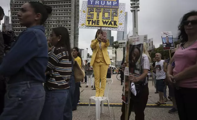 Israelis gather ahead to watch a live broadcast in Tel Aviv's Hostages Square of Israeli-American soldier Edan Alexander being released from Hamas captivity in Gaza, in Tel Aviv, Monday, May 12, 2025. Alexander was abducted during the Hamas-led attack on his base on October 7, 2023. (AP Photo/Oded Balilty)