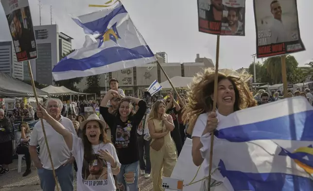 People react as they gather to watch a live broadcast of Israeli-American soldier Edan Alexander to be released from Hamas captivity in Gaza, at a plaza known as the hostages square in Tel Aviv, Monday, May 12, 2025. Alexander was abducted during the Hamas-led attack on his base on October 7, 2023. (AP Photo/Oded Balilty)
