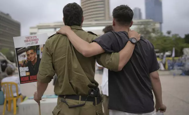 Israelis gather to watch a live broadcast of Israeli-American soldier Edan Alexander to be released from Hamas captivity in Gaza, at a plaza known as the hostages square in Tel Aviv, Monday, May 12, 2025. Alexander was abducted during the Hamas-led attack on his base on October 7, 2023. (AP Photo/Oded Balilty)