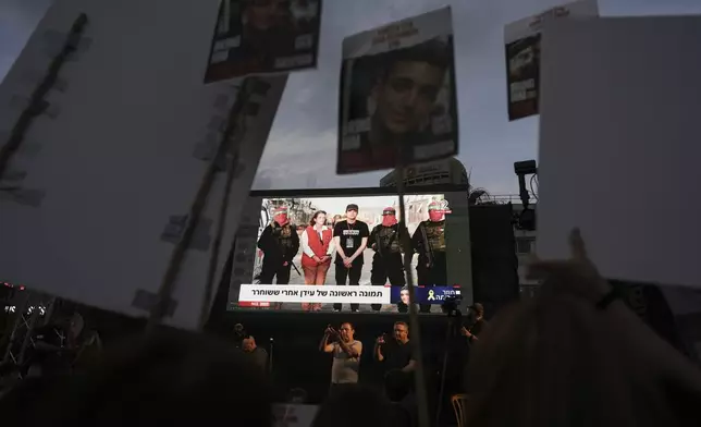 People watch a live broadcast of Israeli-American soldier Edan Alexander as he is released from Hamas captivity in Gaza, at a plaza known as the hostages square in Tel Aviv, Monday, May 12, 2025. Alexander was abducted during the Hamas-led attack on his base on October 7, 2023. (AP Photo/Oded Balilty)